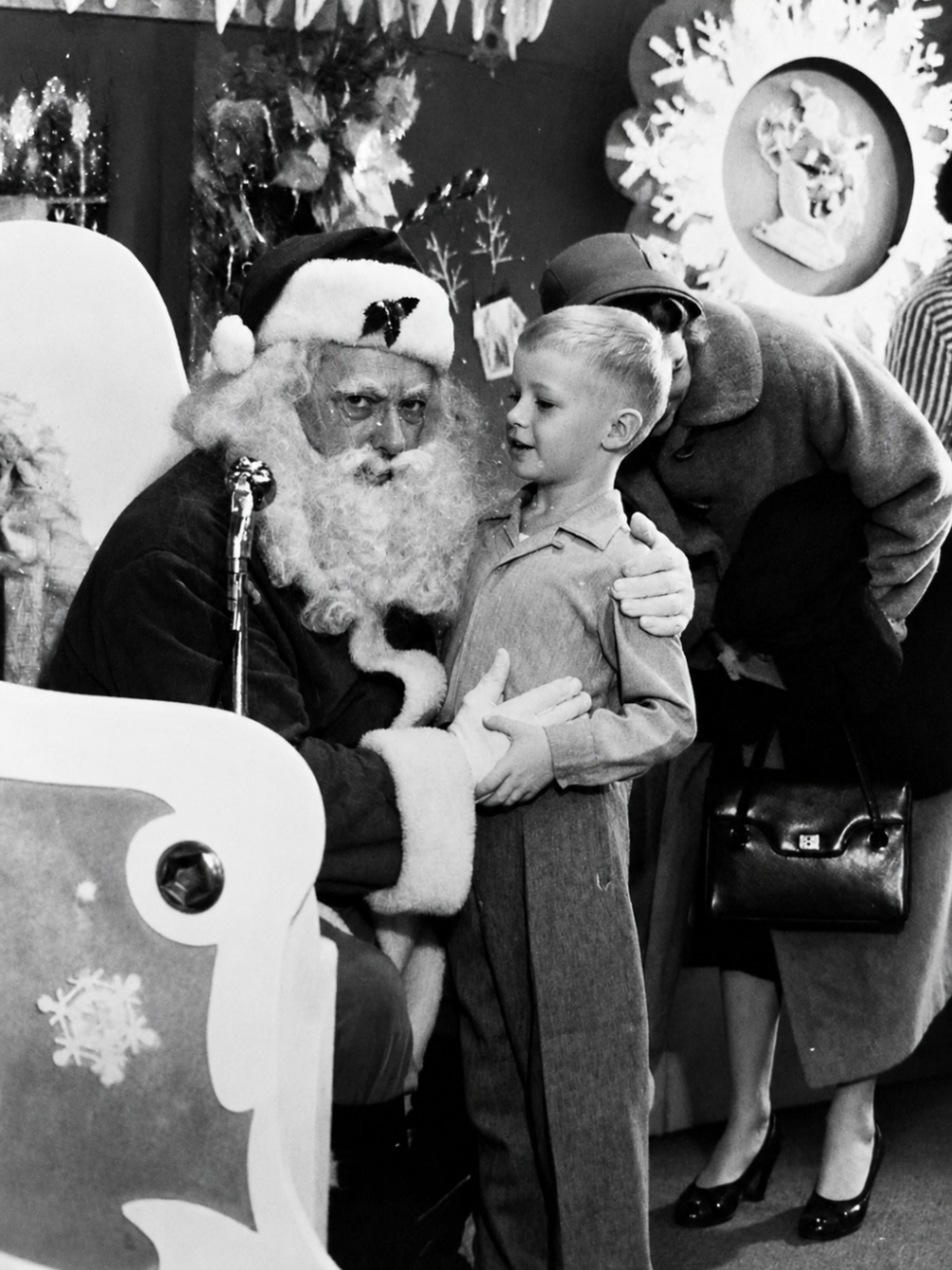 A childhood black and white photo of Dave with Santa
